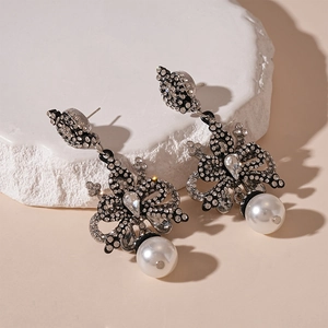 Vintage style bow earrings with rhinestones and white round pearls in silver tone