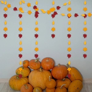 Detail of autumn maple leaf garland with orange and dark red paper leaves for party decor