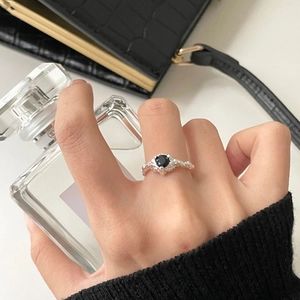 Close-up of S925 silver ring with black diamond and irregular lava texture detail
