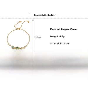 Detail view of 18k gold plated copper bracelet with green oval zircon and blue stones