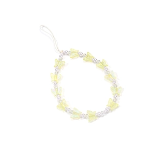 Detailed shot of yellow butterfly beads and transparent acrylic pearls on phone charm
