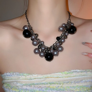 Close-up of irregular pearl fringe necklace with metallic black and grey beads for women