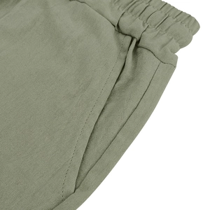 Detail of elastic waistband and reinforced pocket stitching on linen summer shorts