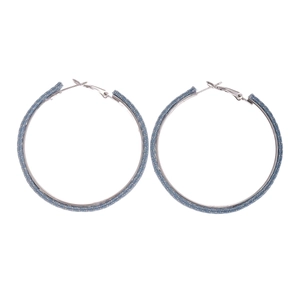 Minimalist silver hoop earrings wrapped in blue denim fabric with white dot pattern