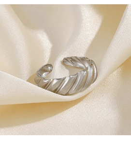 Macro detail of silver croissant twist texture on adjustable stainless steel ring