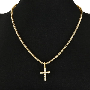 Golden tennis chain necklace with pearl-inlaid cross pendant on black mannequin