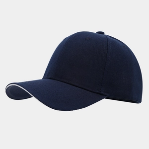 Detail of navy blue baseball cap showing six-panel stitch and white sandwich brim edge