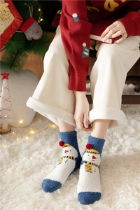 Close-up of fluffy snowman pattern Christmas socks worn in a festive holiday setting