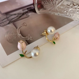 Detailed close-up of tulip-shaped pearl earrings with gold-tone accents and pink petals