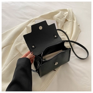 Top view of black lychee grain handbag interior showing zipper pocket and magnetic closure