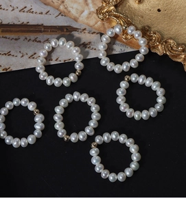 Detailed view of elastic natural freshwater pearl rings with 14K gold filled accent beads