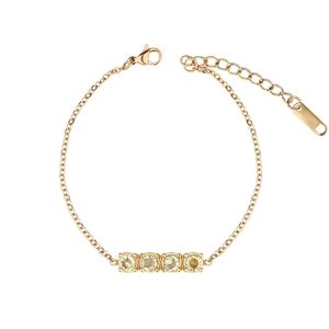 Minimalist gold titanium bracelet with four round yellow gemstones and extension chain