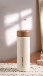 Detail of cream matte thermos with silicone handle and built-in tea strainer feature
