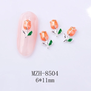 Macro view of 6x11mm alloy tulip nail charms with orange petals and green leaves
