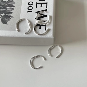 Set of minimalist 925 sterling silver irregular wavy open rings on a clean white background