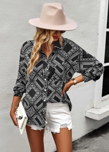 Detail of floral print on long sleeve button-up shirt with elegant black and white pattern
