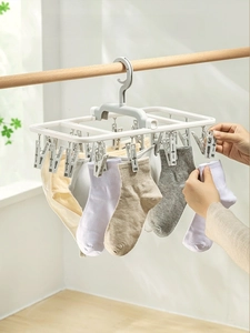 Foldable laundry drying rack with multi-clips for socks and underwear on a balcony
