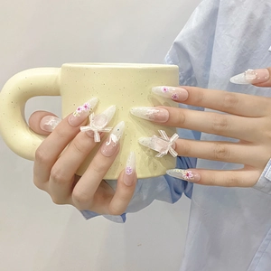 Handmade stiletto press-on nails with 3D bows, pink flowers, and swan nail art