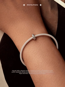 Close-up of vintage oxidized 925 silver spacer bead on a mesh bracelet worn on wrist
