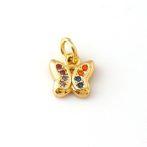 Detail of gold butterfly pendant with colorful gemstones for DIY jewelry crafts