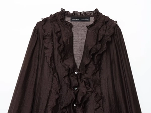 Detail of dark coffee brown ruffled shirt with pearl buttons and lightweight fabric
