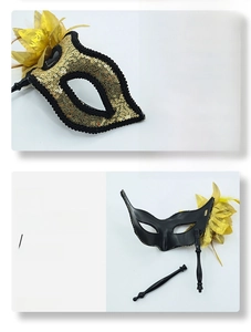 Detail of glitter sequins and detachable handle on masquerade feather eye mask