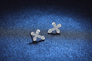 Macro shot of s925 silver cross stud earrings with sparkling pavé moissanite stones