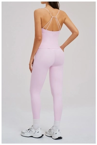 Back view of light pink crisscross sports bra and high-waisted yoga leggings