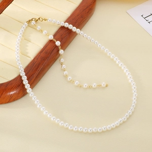 French vintage pearl titanium steel necklace with gold lobster clasp on jewelry display