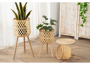 Detailed view of three sizes of bamboo woven plant stands with solid wood tripod legs