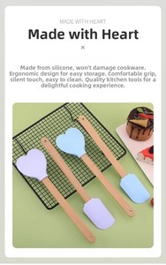 Macro view of lilac and sky blue heart-shaped silicone spatulas with natural beech wood handles