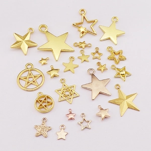 DIY gold and rose gold alloy star pendants for necklaces and bracelets on white backdrop