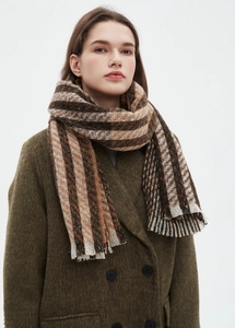 Close-up of striped knit scarf with brown, beige tones and soft fringe edges