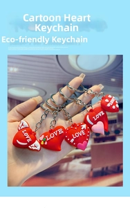 Macro detail of red silicone heart keychains with silver chains and Love lettering