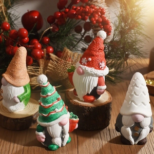 Detailed close-up of four handcrafted Christmas gnome figurines on a festive wooden base