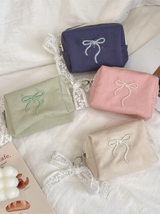 Large bow embroidery canvas cosmetic bags in four pastel colors on white fabric
