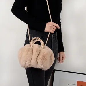 Plush faux rabbit fur handbag in beige with braided handles and adjustable shoulder strap