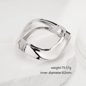 Detailed view of irregular criss-cross open silver bangle with size and weight specs