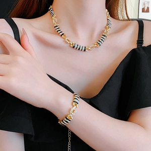 Detail of gold-tone jewelry set with leopard print patterns and sparkling rhinestones