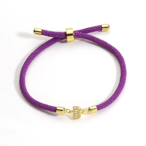 Adjustable purple braided rope bracelet with a gold metal letter B pendant and crystals