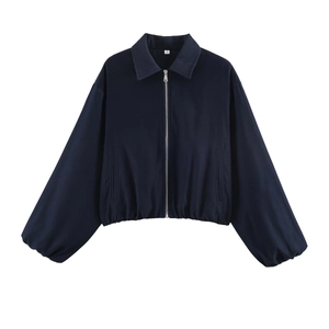 Detail of navy blue cropped jacket with silver zipper and classic collar design