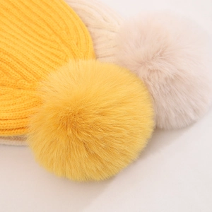 Macro shot of fluffy pom-poms and high-density knit texture on children's winter hats
