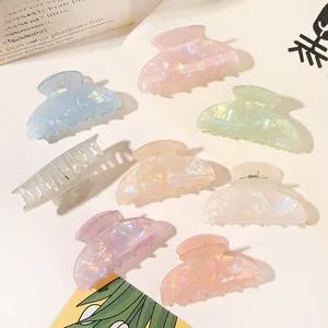 Detail shot of multi-colored iridescent hair claws in pastel resin finishes