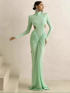 Elegant mint green long-sleeved mermaid gown with side cutouts and draped skirt detail