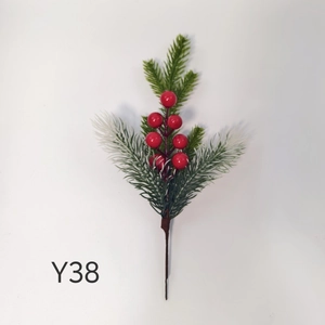 Close-up of artificial Christmas pine needles with bright red berries for DIY holiday decor