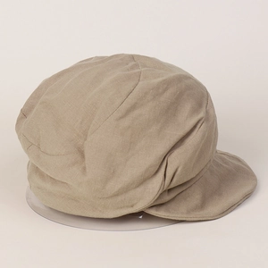 Close-up of khaki linen newsboy cap showing natural breathable fabric texture and stitching