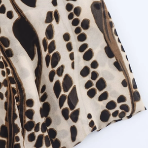 Macro view of leopard print chiffon fabric showing brown and black animal pattern details