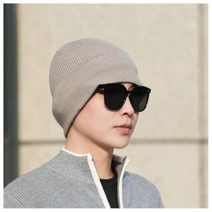 Close-up of oatmeal knitted beanie with premium texture and warm thermal fleece lining