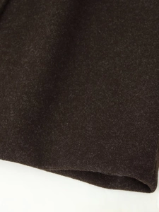 Detailed macro view of dark brown wool fabric texture and stitching on the winter coat