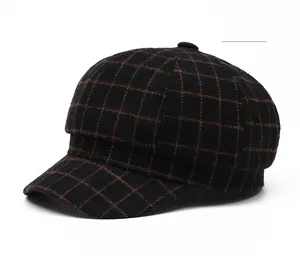 Close-up of vintage black and brown plaid newsboy cap with wool texture and top button detail